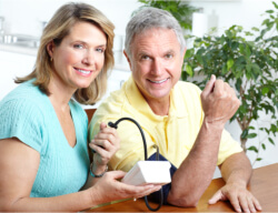 caregiver checking the blood pressure of an elder
